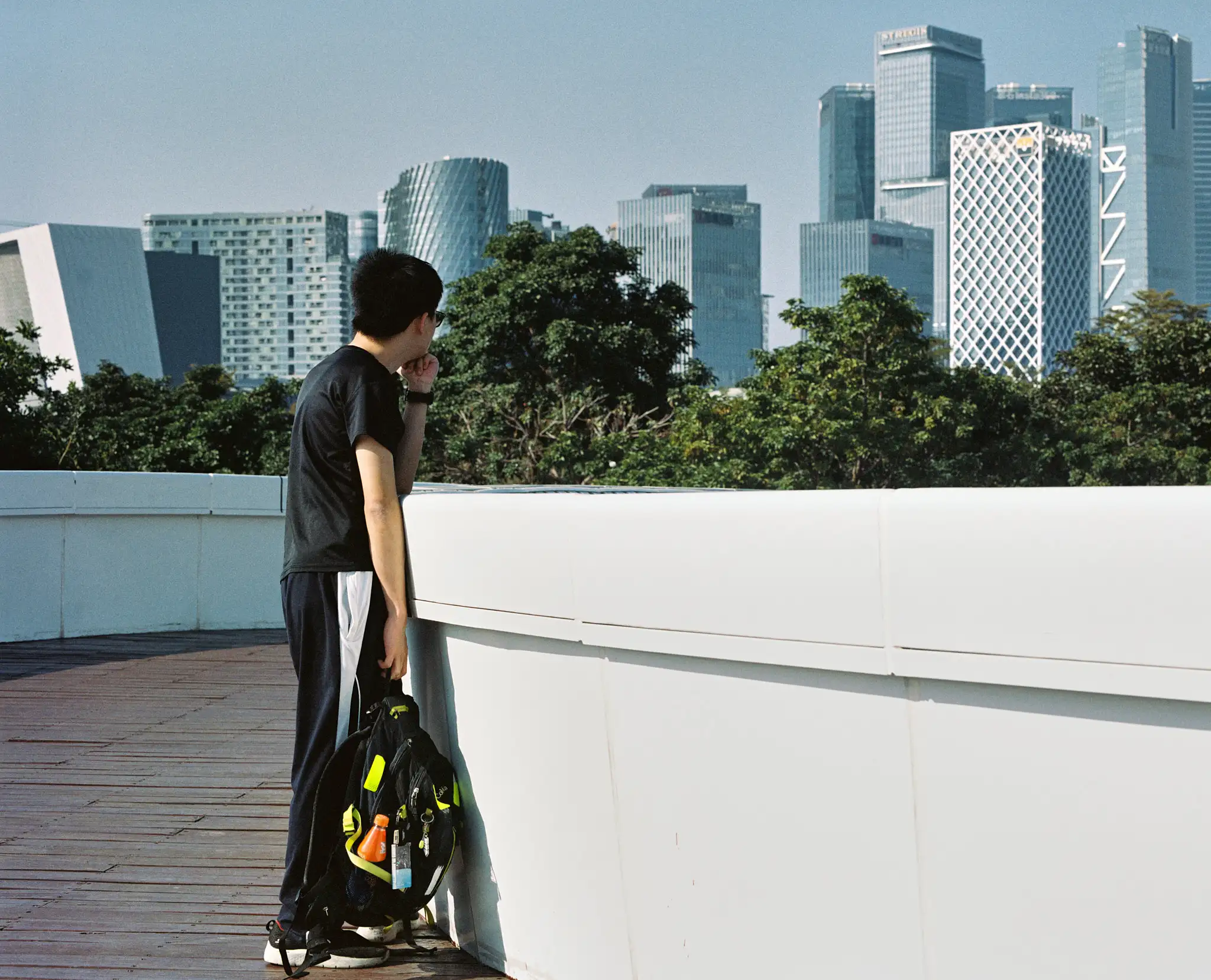 Tim (WallBreaker No.4), standing on a bridge, looking at the Shenzhen skyline